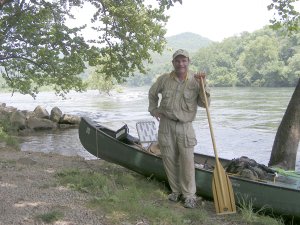 Jack Butt of Fayetteville stands along the White River at Buffalo City in June after hiking and paddling his way down all 132 floatable miles of the Buffalo River from Ponca to the White River. Butt embarked on the journey to celebrate his 60th birthday.