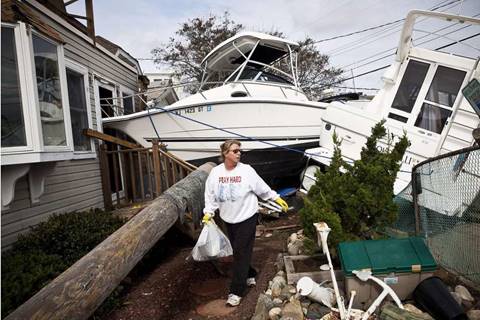 Regina Yahara-Splain cleans out her home after it was damaged by Superstorm Sandy in Highlands, N.J., in 2012. Photo: Andrew Burton, Getty Images
