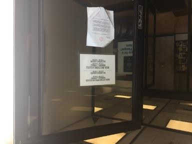 A letter posted on the front entrance of the downtown Richmond post office informs postal customers of the facility's planned closure. (Tom Lochner)