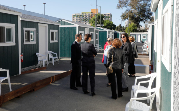 City officials and community members tour the newest Tuff Sheds community at Northgate Avenue and 27th Street in Oakland, Calif., on Monday, May 7, 2018. This is the second Tuff Sheds community opening to address the homeless crisis.  (Laura A. Oda/Bay Area News Group)