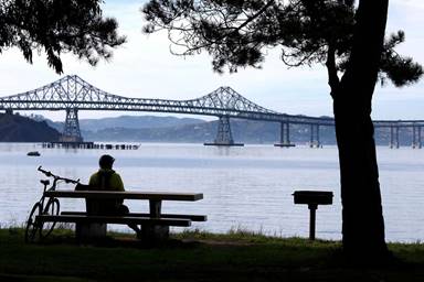 Bicyclist David Bullen takes in the view of the crumbling bridge from Point Molate Beach Park in Richmond.