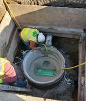 Forde installing base for new manhole on Macdonald