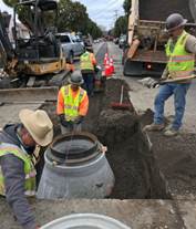 Forde installing a new manhole on 26th Street