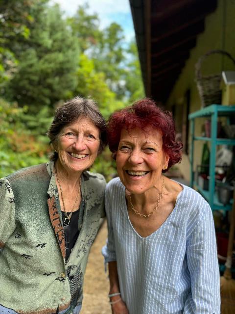 Two women smiling at the camera    Description automatically generated