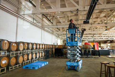 Winemaker and co-owner Kevin Brown set up lights for a comedy show later at their Riggers Loft Wine Company in Richmond, Calif., on Saturday, March 30, 2024. (Ray Chavez/Bay Area News Group)