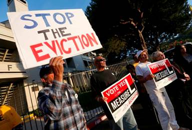 Jose Gonzalez, Vincent Justin, Luis Ugalde and former Richmond mayor Gayle McLaughlin, from left, listen to speakers as tenants rally at the Creekview Apartments in Richmond, Calif., on Thursday, Oct. 6, 2016. Justin recently moved out after living there for 22 years. More than 100 renters are being evicted from the apartments. Tenants are demanding that the owner, PMI Properties, halt evictions and let the remaining tenants stay in the recently refurbished apartments. (Jane Tyska/Bay Area News Group)