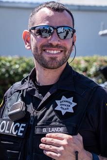 Image may contain: 1 person, smiling, sunglasses, beard, outdoor and closeup