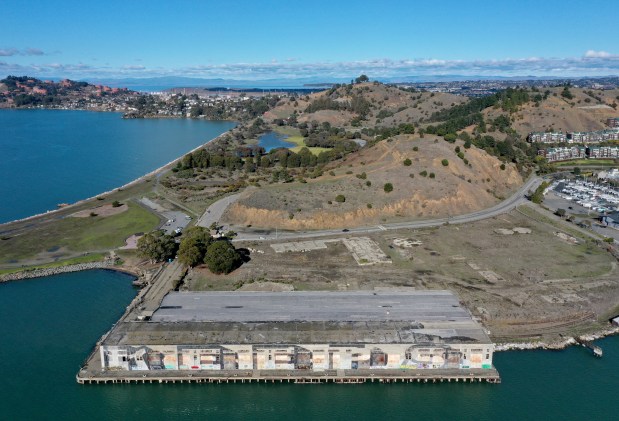 A former industrial plot of land is seen from this drone view along Brickyard Cove Road near Dorman Drive in Richmond, Calif., on Monday, Dec. 12, 2022. The proposed Terminal One project of 154 single-family homes over 13.8 acres of prime waterfront real estate is going back to the drawing board. (Jane Tyska/Bay Area News Group)