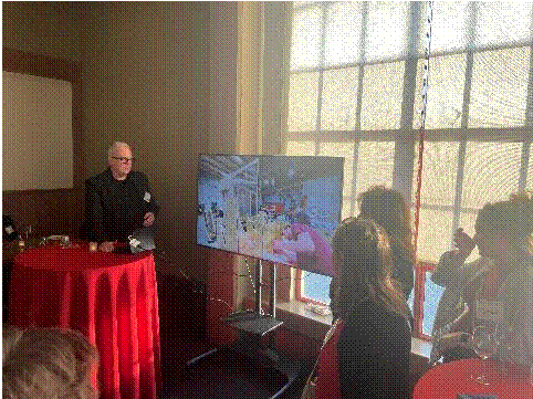 A person standing in front of a television Description automatically generated with medium confidence,Figure 8 - Puppy corral
